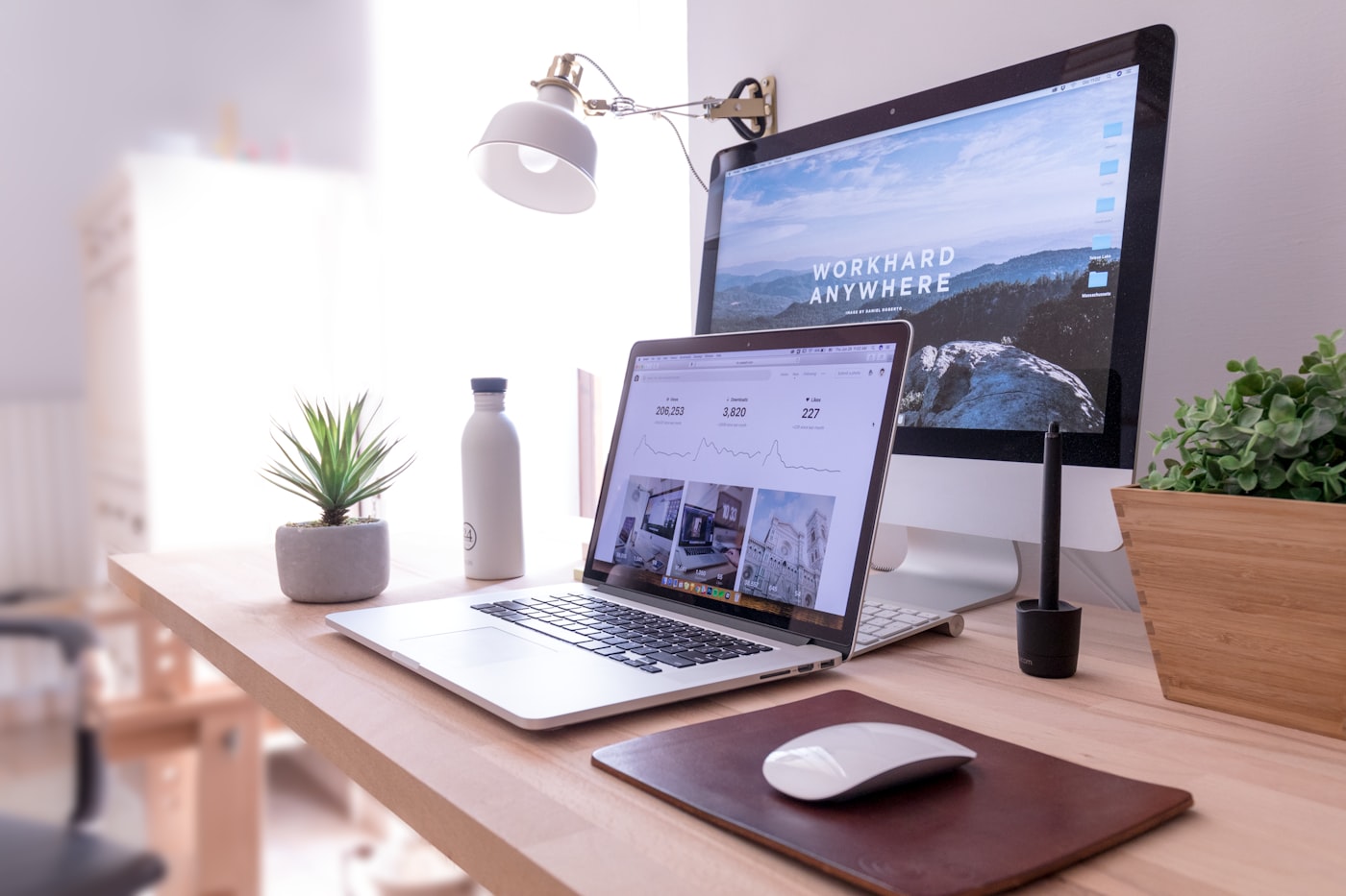 A business website open on a laptop and monitor